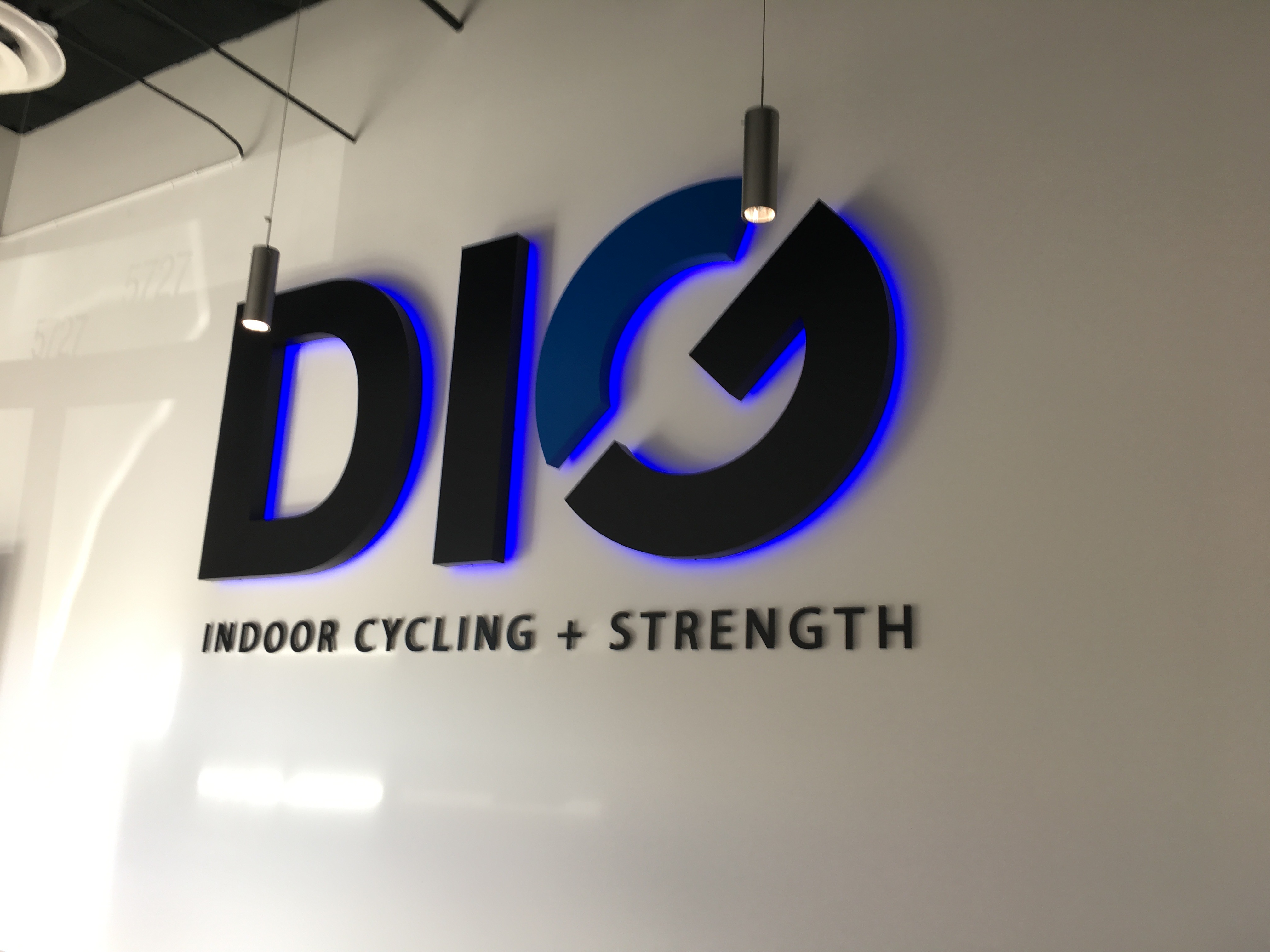 DIG Indoor Cycling + Strength studio logo wall